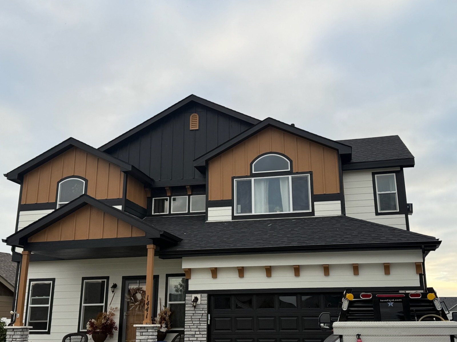 Two-story exterior repaint with white siding and dark trim in Fort Collins