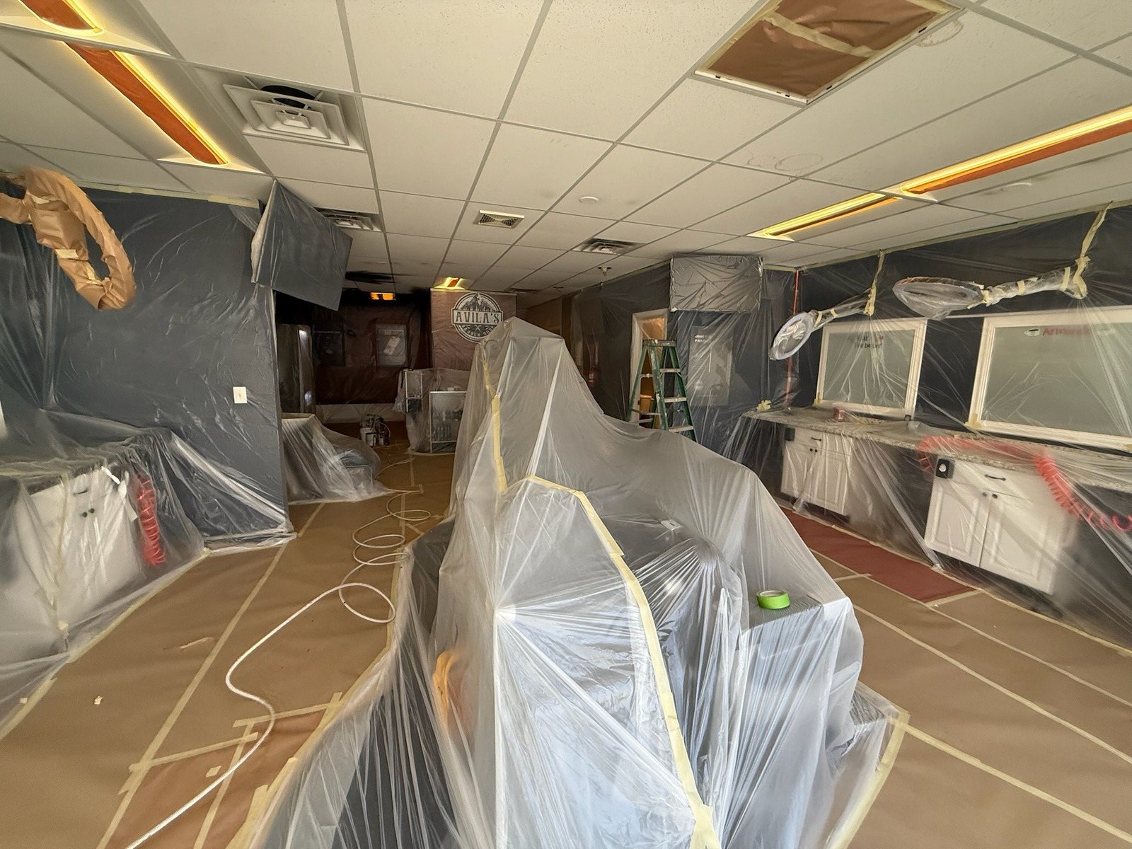 Commercial space fully masked and covered before painting in Greeley